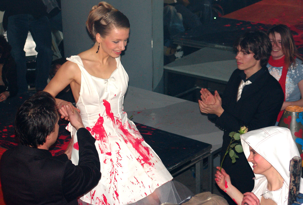 a woman in a bloody dress